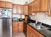 Thumbnail 15 of 32 - Kitchen with Stainless Steel Appliances at Integrity Gold Coast Apartments in Lakewood, Ohio, 44102