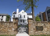 Thumbnail 6 of 29 - A sign that says Reserve Overlook Apartments stands in front of a gate.