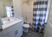 Thumbnail 19 of 29 - A bathroom with a toilet, sink, and shower.