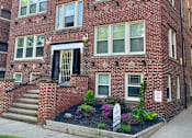 Thumbnail 23 of 37 - A red brick building with a black door and windows. at Integrity Cleveland Heights Apartments, Apartments, Cleveland Heights, OH