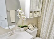 Thumbnail 33 of 36 - Upgraded apartment bathroom with white cabinets.