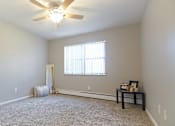 Thumbnail 34 of 36 - Carpeted apartment bedroom option with ceiling fan light.