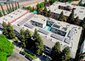 Thumbnail 15 of 15 - Aerial drone image of building with view of solar panels.