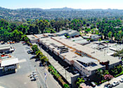 Thumbnail 17 of 18 - Aerial drone photo of Woodbridge Park Apartments, showing white solar roofs and Solar Panels.