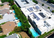 Thumbnail 22 of 23 - Aerial drone picture of the building showing solar panels and white energy-efficient roof.