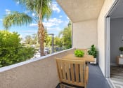 Thumbnail 14 of 21 - Large balcony with seating space and view of neighborhood of Chandler Circle Apartments.