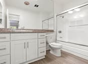 Thumbnail 6 of 14 - Modern styled bathroom with shower and tub.