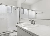 Thumbnail 6 of 18 - Modern styled bathroom with shower and tub.