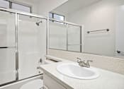 Thumbnail 5 of 16 - Modern styled bathroom with shower and tub.
