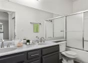 Thumbnail 8 of 20 - Modern styled bathroom with shower and tub.
