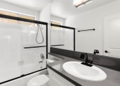 Thumbnail 8 of 24 - Modern styled bathroom with shower and tub.