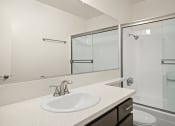 Thumbnail 8 of 15 - Modern styled bathroom with shower and tub.