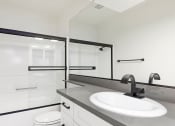 Thumbnail 8 of 22 - Modern styled bathroom with shower and tub.