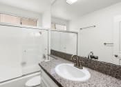 Thumbnail 9 of 24 - Modern styled bathroom with shower and tub.