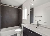 Thumbnail 10 of 22 - Modern styled bathroom with tub and shower.