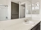 Thumbnail 14 of 28 - Modern styled bathroom with shower and tub.