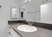 Thumbnail 11 of 21 - Modern styled bathroom with shower and tub.