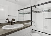 Thumbnail 10 of 31 - Modern styled bathroom with shower and tub.