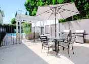 Thumbnail 19 of 23 - Courtyard barbecue and seating area with umbrella.