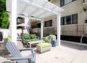 Thumbnail 18 of 23 - Community barbecue area with seating and lounging space.