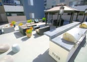 Thumbnail 20 of 29 - Barbecue and outdoor community seating gathering area.