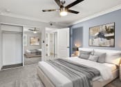 Thumbnail 5 of 29 - Large bedroom with ceiling fan.