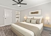 Thumbnail 7 of 15 - Carpeted bedroom with large mirrored closet and ceiling fan.