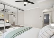 Thumbnail 7 of 15 - Carpeted bedroom with ceiling fan and large mirrored closet.