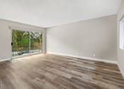 Thumbnail 16 of 28 - Hardwood floored bedroom with direct balcony access.