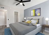 Thumbnail 12 of 21 - Carpeted bedroom with ceiling fan and private bathroom.