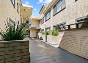 Thumbnail 16 of 23 - Drought-tolerant greenery and courtyard at Woodridge Apartments.