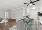 Thumbnail 5 of 24 - Large hardwood floored dining room with view of kitchen.