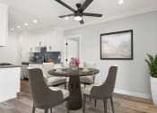 Thumbnail 2 of 22 - Dining room with hardwood floors, ceiling fan, and view of modern kicthen.