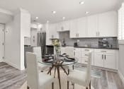 Thumbnail 1 of 19 - Hardwood floored dining room with view of gorgeous tiled kitchen.
