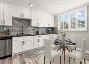 Thumbnail 2 of 19 - Hardwood floored dining room with view of gorgeous tiled kitchen.