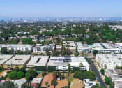 Thumbnail 14 of 14 - Aerial drone image of Rose Apartments and surrounding neighborhood.