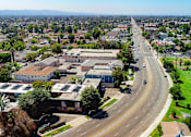 Thumbnail 15 of 16 - Aerial drone photo of 10620 NoHo showing solar panels and energy-efficient white roofing.