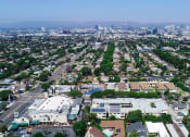 Thumbnail 24 of 24 - Aerial drone view of National Apartments depicting roof-mounted solar panels and adjacency to Whole Foods Market.