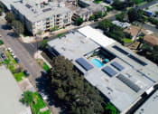 Thumbnail 13 of 14 - Aerial drone image of Rose Apartments and courtyard with pool.