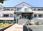 Thumbnail 21 of 23 - Entrance to Woodridge Apartments with drought tolerant landscape.