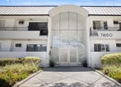 Thumbnail 22 of 24 - Entrance to National Apartments with drought-resistant greenery.
