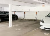 Thumbnail 19 of 24 - Large covered parking lot with EV Chargers.