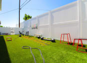 Thumbnail 17 of 22 - Outdoor fitness center with free weights, jump ropes, and medicine balls.