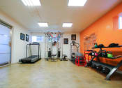 Thumbnail 15 of 22 - On-site gym with treadmill, weight machines, and free weights.