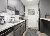 Thumbnail 1 of 21 - White tiled kitchen with stainless steel fridge, microwave, and oven.
