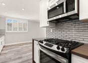 Thumbnail 14 of 19 - Wrap around kitchen with stainless steel microwave and oven.