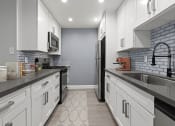 Thumbnail 4 of 29 - Brand new kitchen cabinets, back splash, quartz stone counter tops, and stainless steel appliances with fridge!