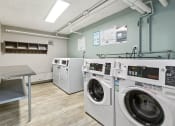 Thumbnail 21 of 25 - On-site laundry room with washers and dryers.