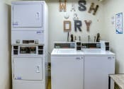 Thumbnail 16 of 22 - Clean and well-maintained communal laundry room.