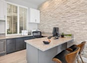 Thumbnail 23 of 27 - Stylish modern leasing office with same stone accent wall found in apartments
